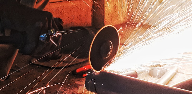 person grinding pipe steel wool photography