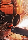 person grinding pipe steel wool photography