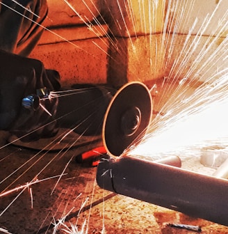 person grinding pipe steel wool photography