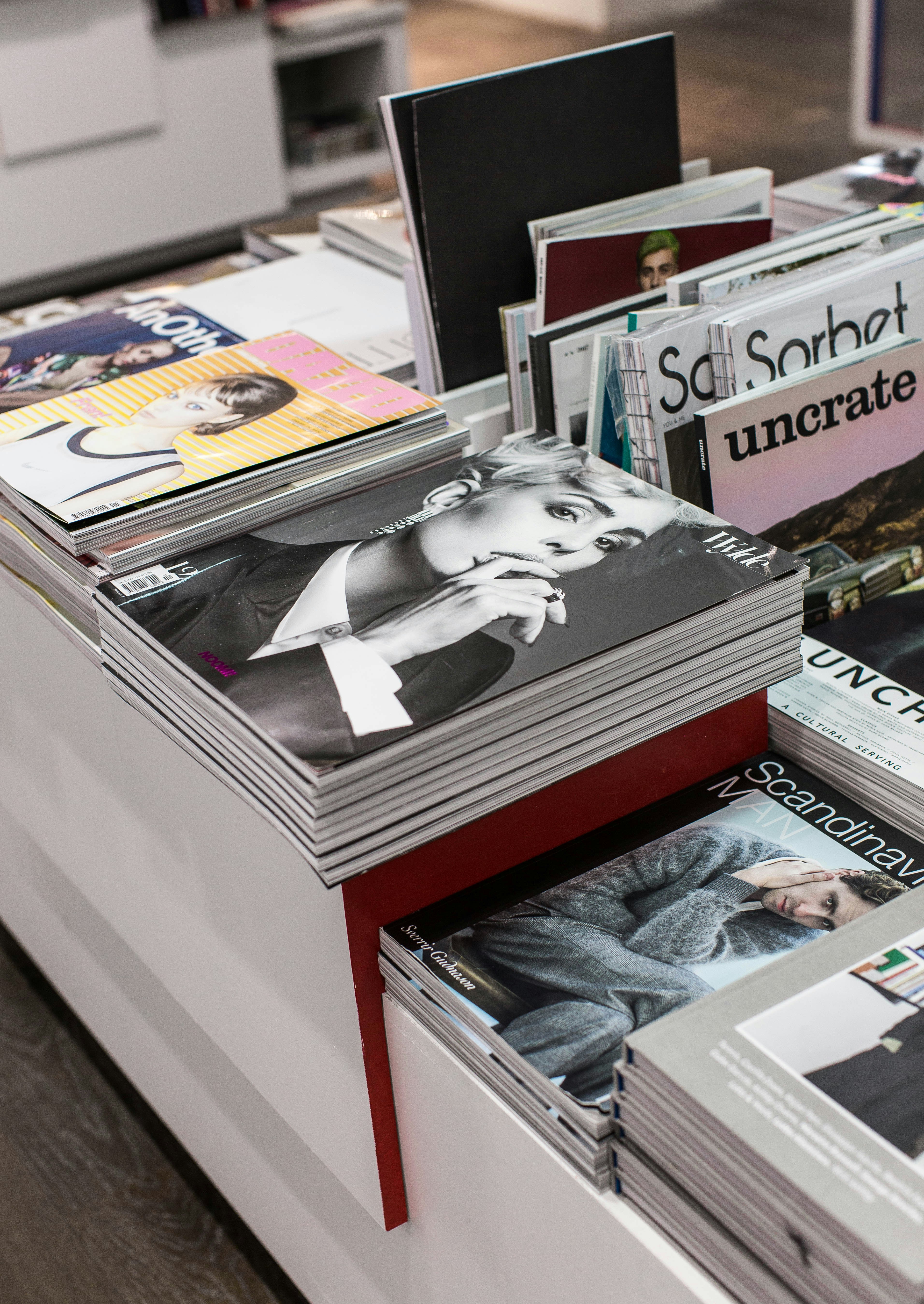 stack of assorted-title book lot arranged on white wooden table