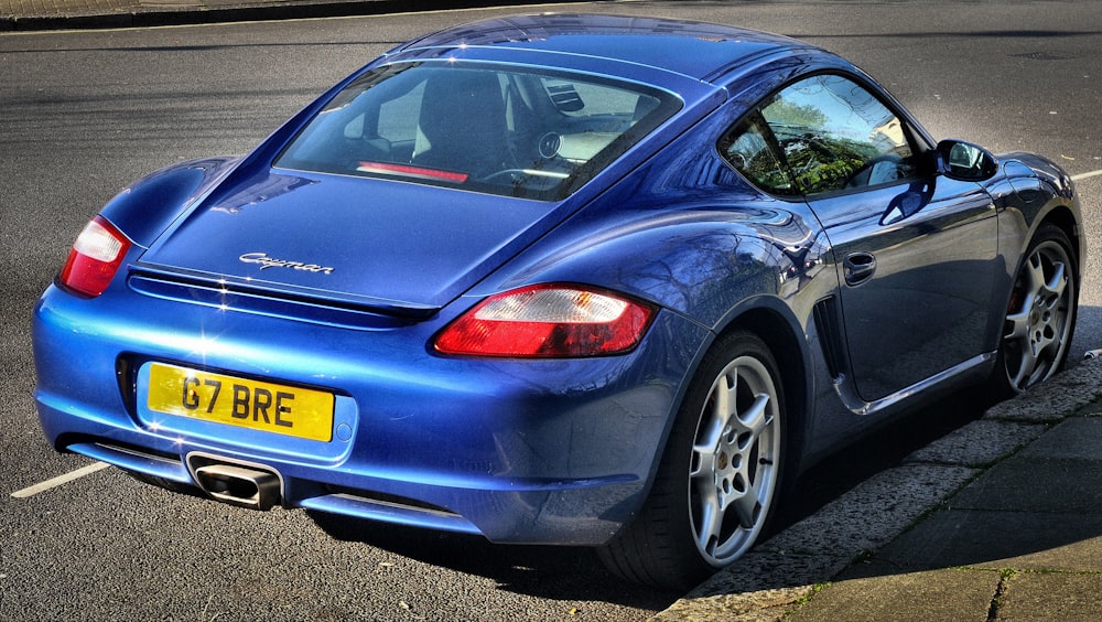 blue coupe on road