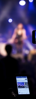 people taking videos during concert