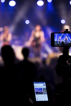 people taking videos during concert