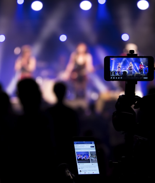 people taking videos during concert