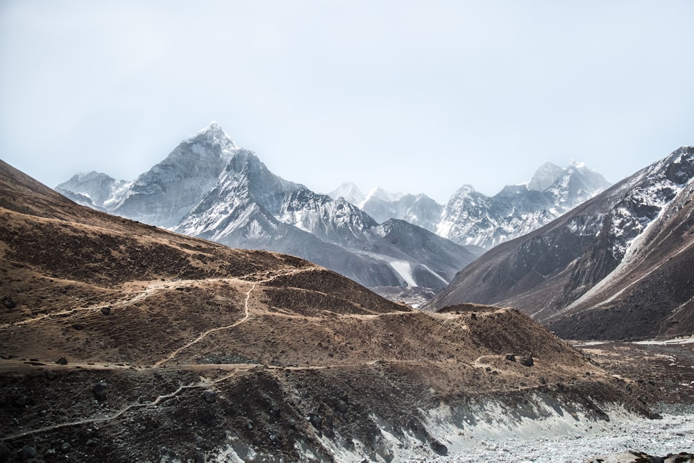 landscape photo of mountains under white clouds