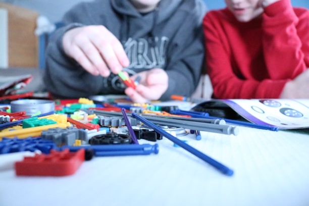 A parent and child happily assembling a role-playing set together in a bright room.