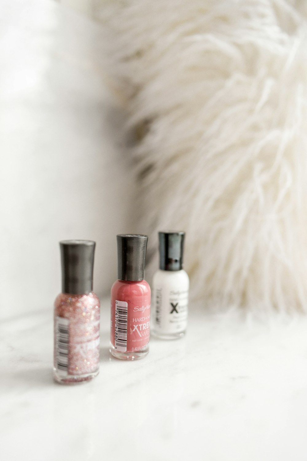 pink, red, and white nail polish bottles