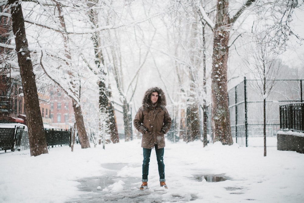 standing person on white snow field during daytime