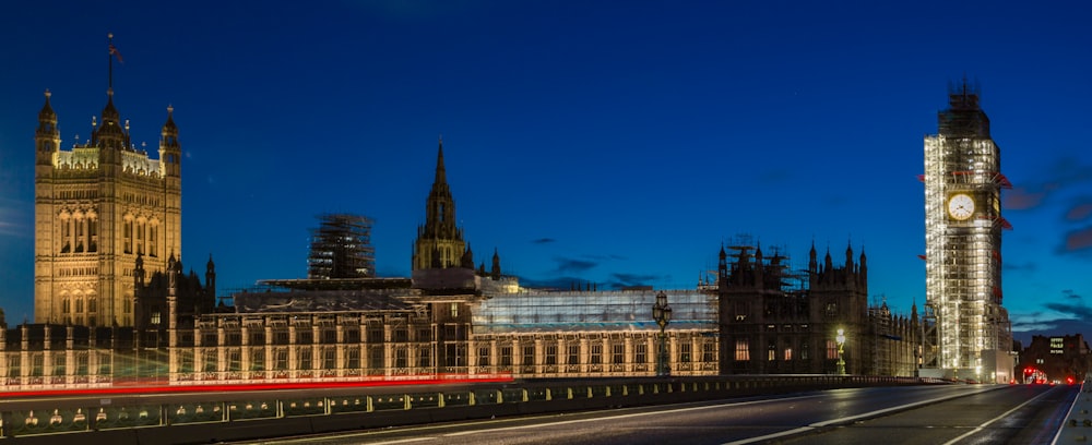 brown concrete building near tower at nighttime