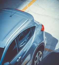 Front view of a shiny used car parked on a sunny street