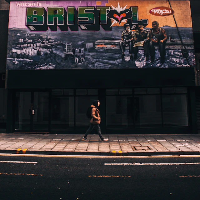 person walking on street beside store