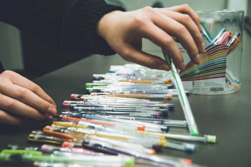 Volunteers sorting brightly colored pencils and notebooks.