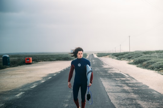 person walking on road in Sagres Portugal