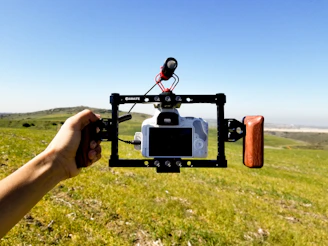 A traveler filming a cinematic vlog with a camera overlooking mountains.