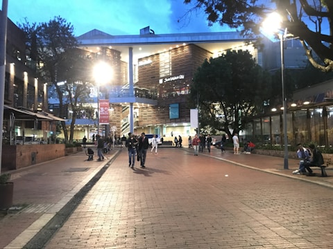 A revitalized downtown block with mixed-use buildings, green spaces, and pedestrians enjoying the urban environment.