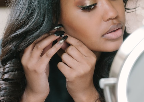 woman in black shirt wearing earring