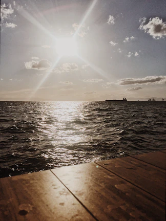 Morning light reflecting off the waves as the ship approaches port.