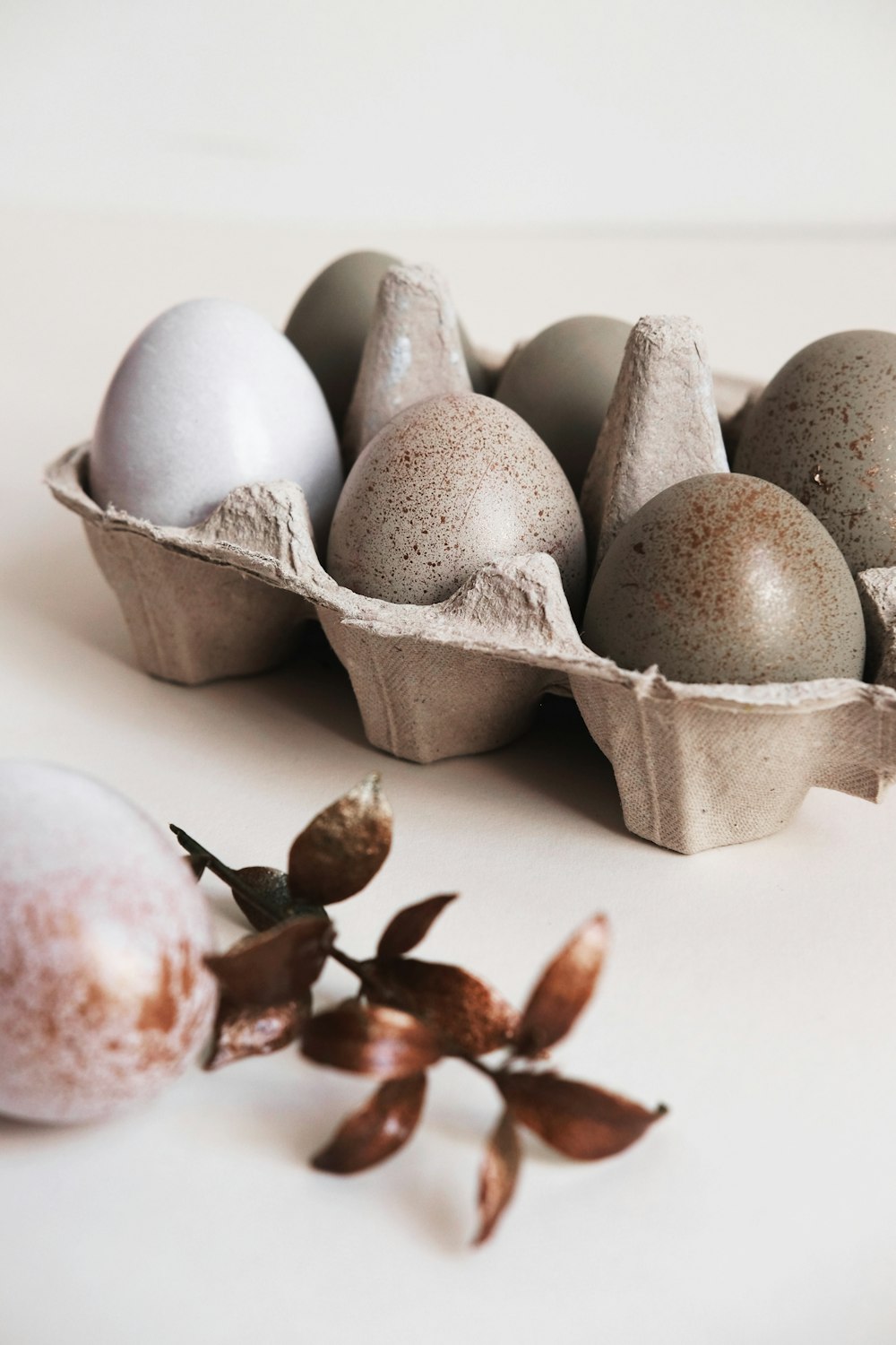 six gray poultry eggs on brown tray