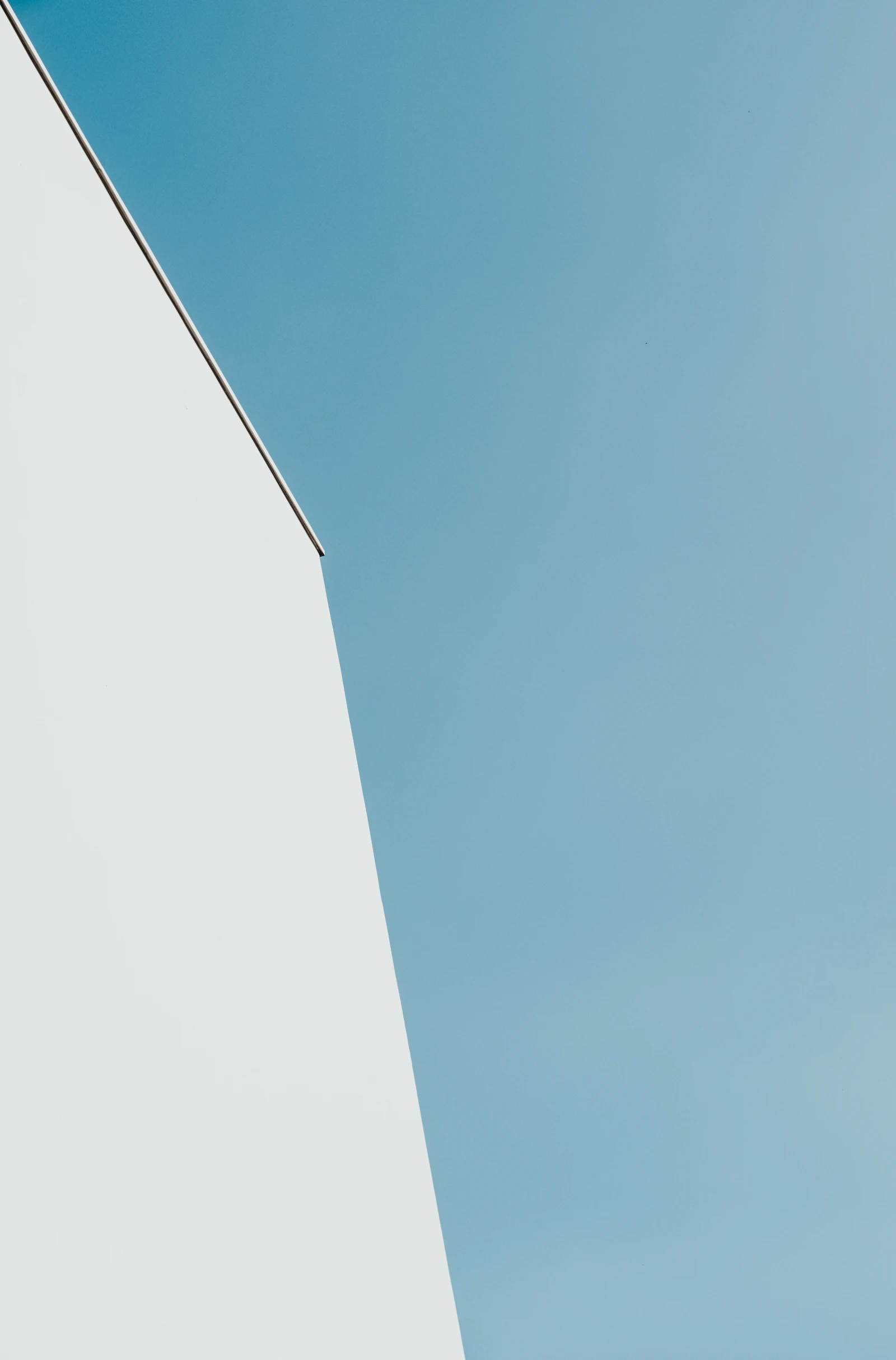 White minimalist office building rising against a clear sky