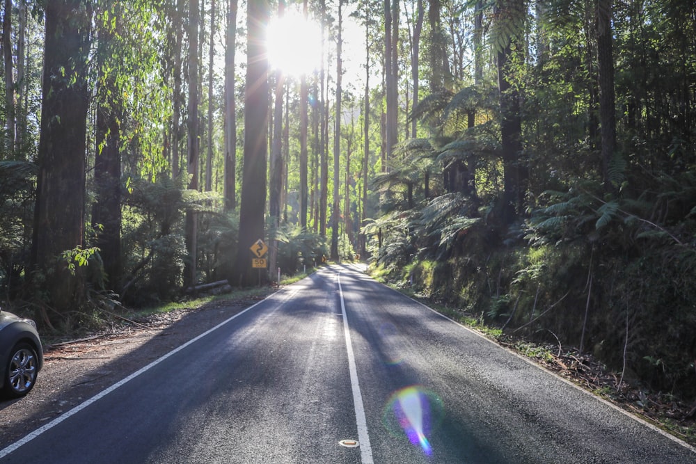 photo of vehicle parked beside paved road