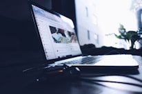 A serene workspace with a laptop displaying Radhika Digiverse’s online store on a green-themed screen.