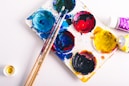 brown paint brushes on assorted-color paint palette