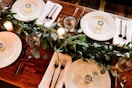 white ceramic dinner plate set on brown wooden table