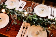 white ceramic dinner plate set on brown wooden table