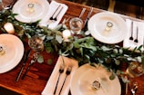 white ceramic dinner plate set on brown wooden table