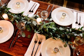 white ceramic dinner plate set on brown wooden table