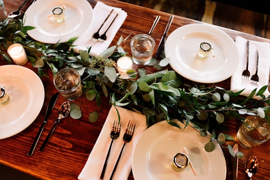 white ceramic dinner plate set on brown wooden table