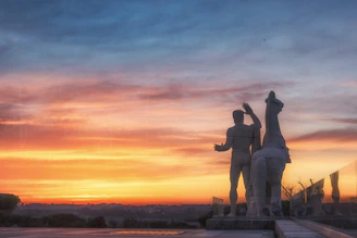 A striking stallion silhouetted against a vibrant sunset sky, embodying strength and nobility.