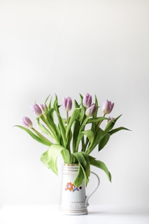 selective focus photography of purple tulip flower arrangement