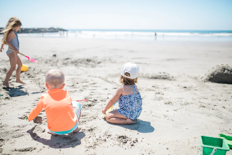 Three children playing and splashing in the sea on a sunny beach