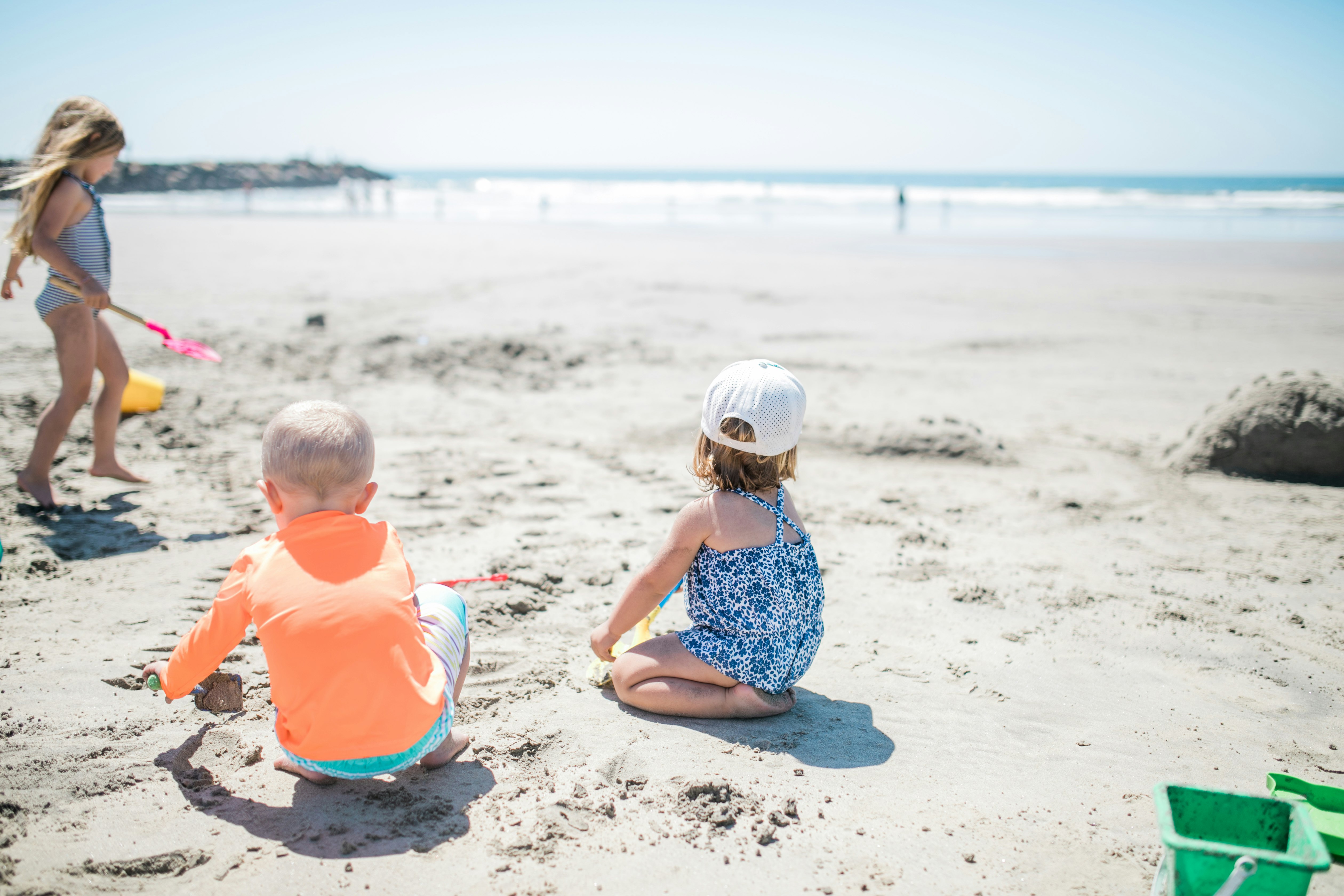 three children playing at the beach