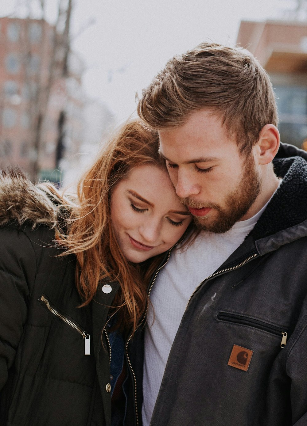 man hugging woman standing on road