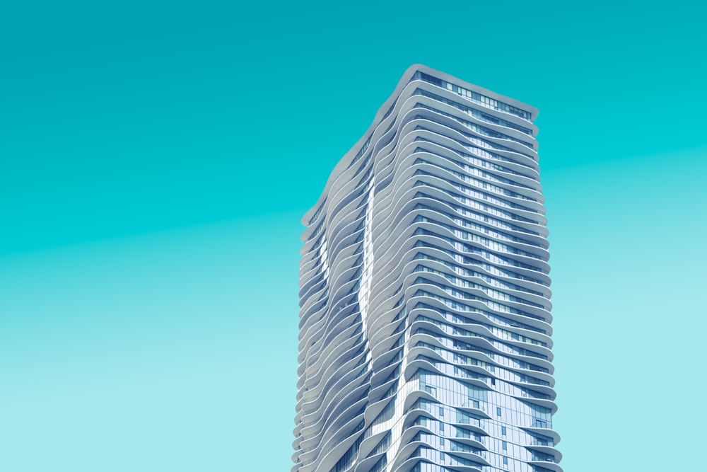 gray high rise building with teal background