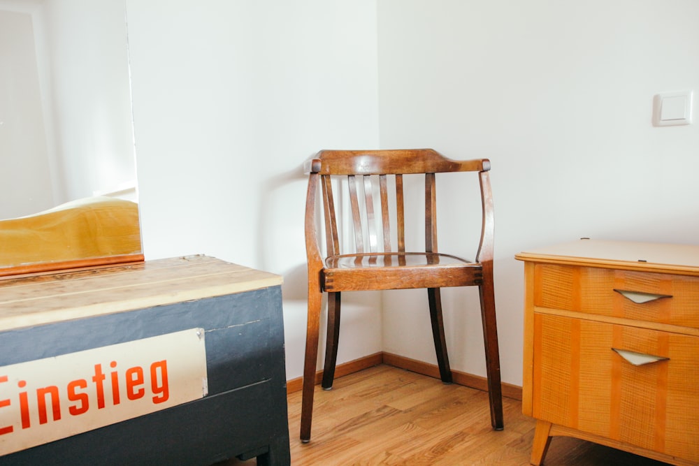 a wooden chair sitting next to a wooden dresser