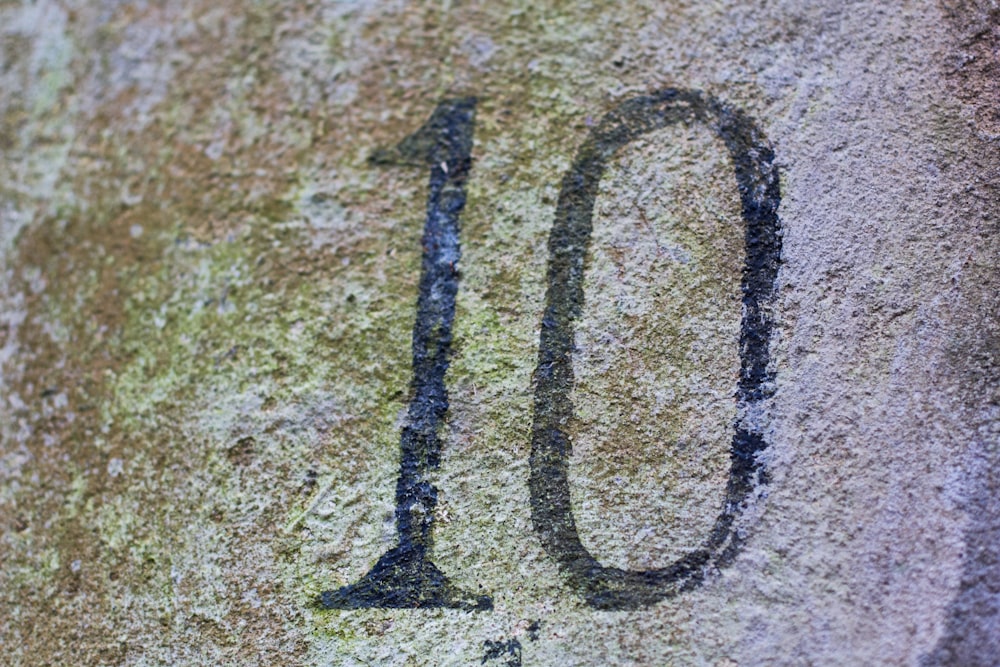 a close up of a number on a rock