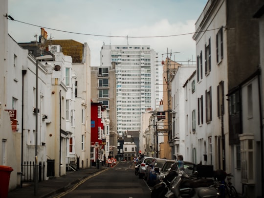 cars beside road between buildings in Brighton United Kingdom