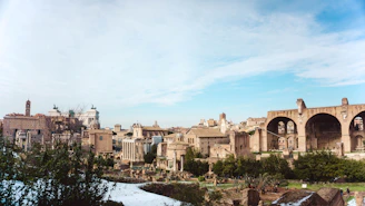 A panoramic view of the ancient Cunziria village with scaffolding and restoration work in progress under a clear sky
