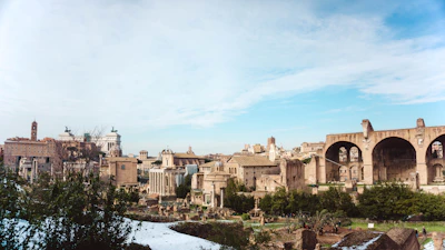 A panoramic view of the ancient Cunziria village with scaffolding and restoration work in progress under a clear sky