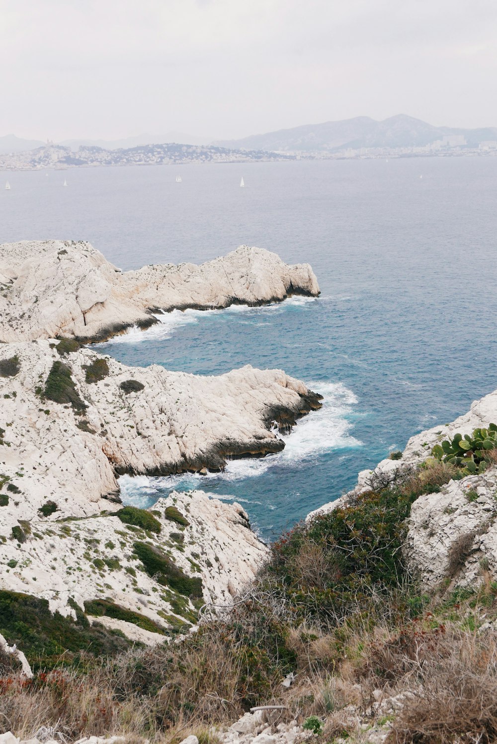 body of water beside white rock formations