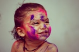 selective focus photography toddler girl with face paint