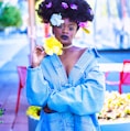 woman wearing blue denim jacket with flowers on hair