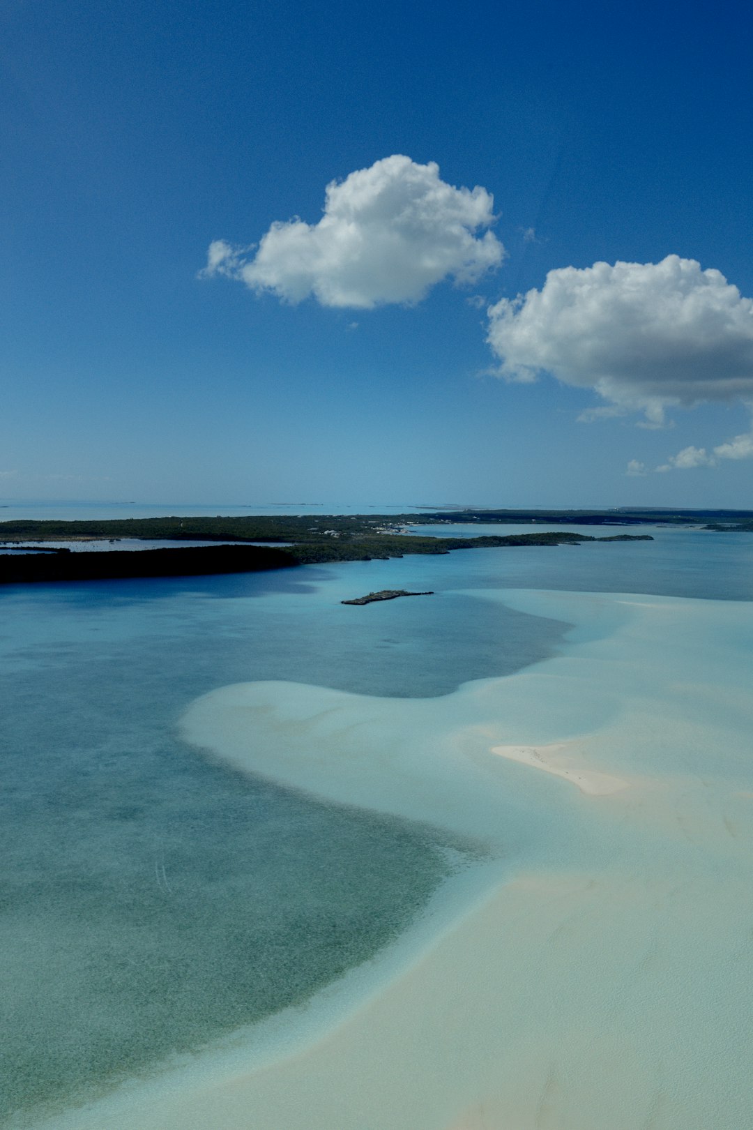 shallow body of water under white clouds