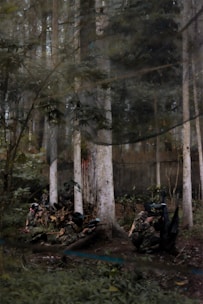 People enjoying an outdoor paintball game in a wooded area.