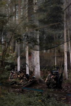 A team playing paintball in a wooded outdoor arena.