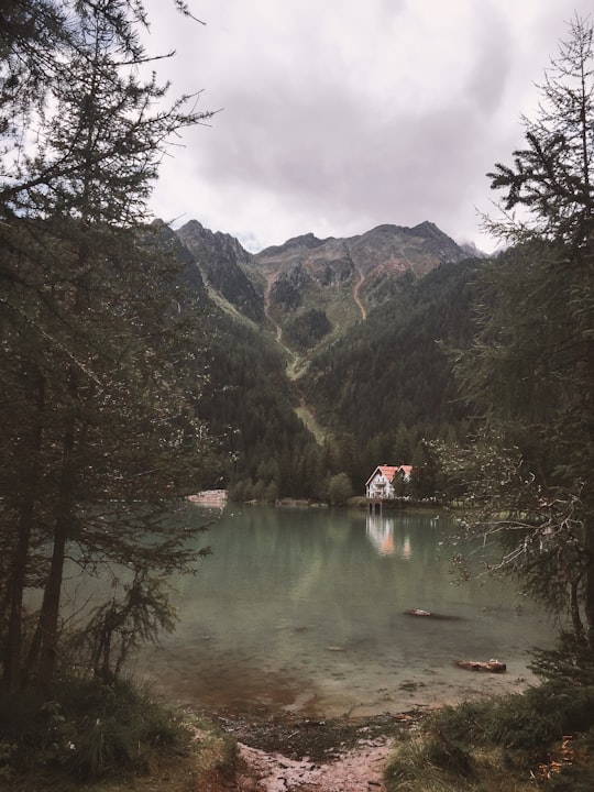 white house under the mountain in Antholzer See Italy