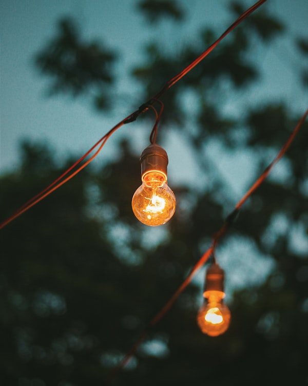 Outdoor lamp glowing against the night sky